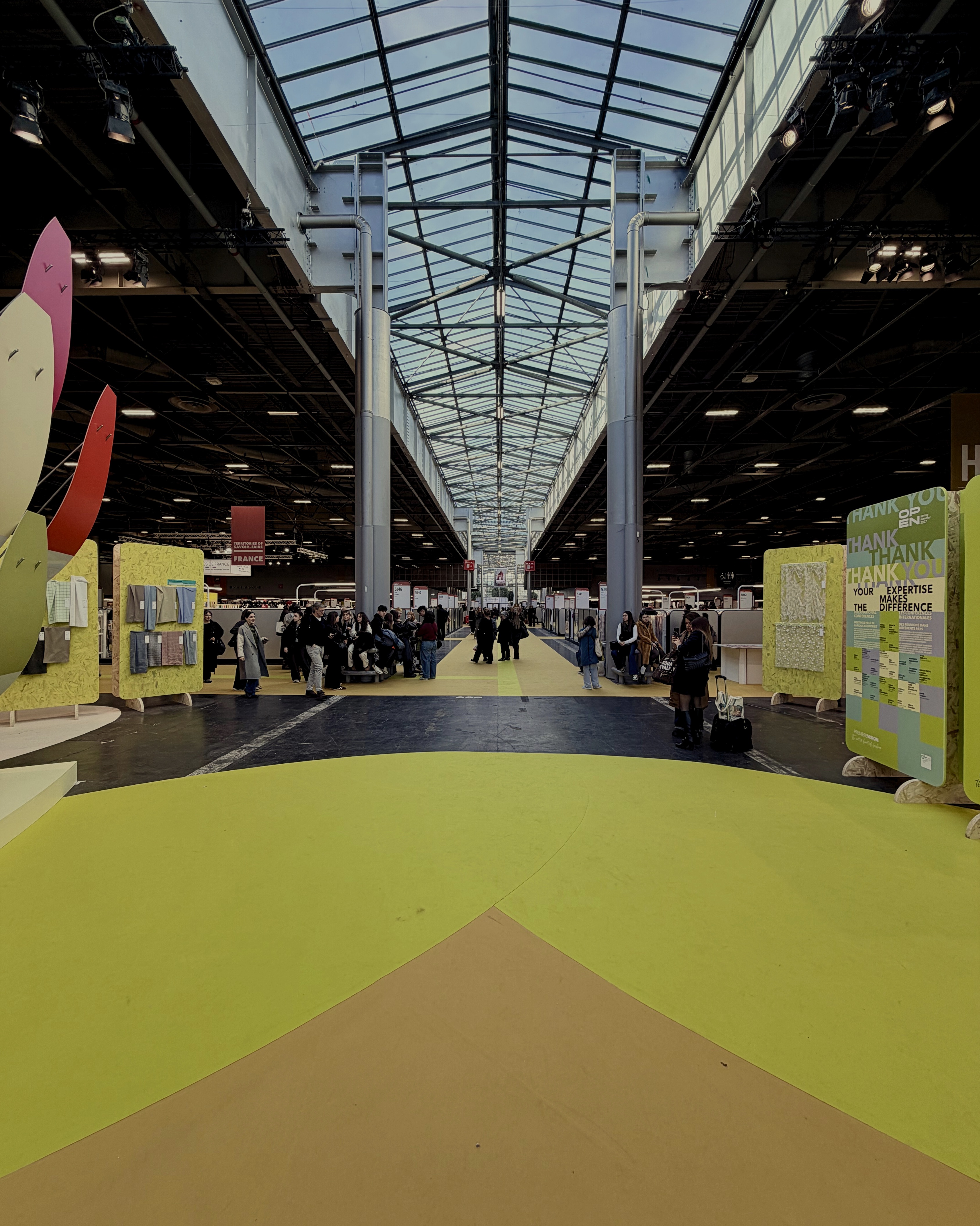 Textile trade show floor showcasing materials used in event merchandise production