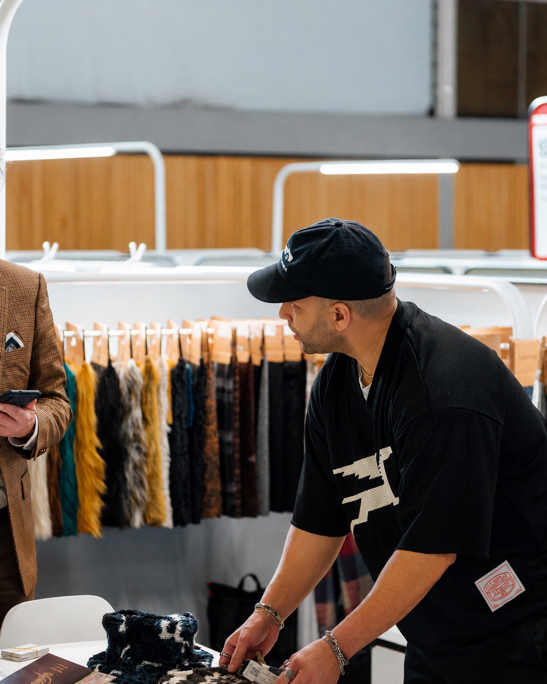 Reviewing fur and fabric swatches at a sourcing trade show